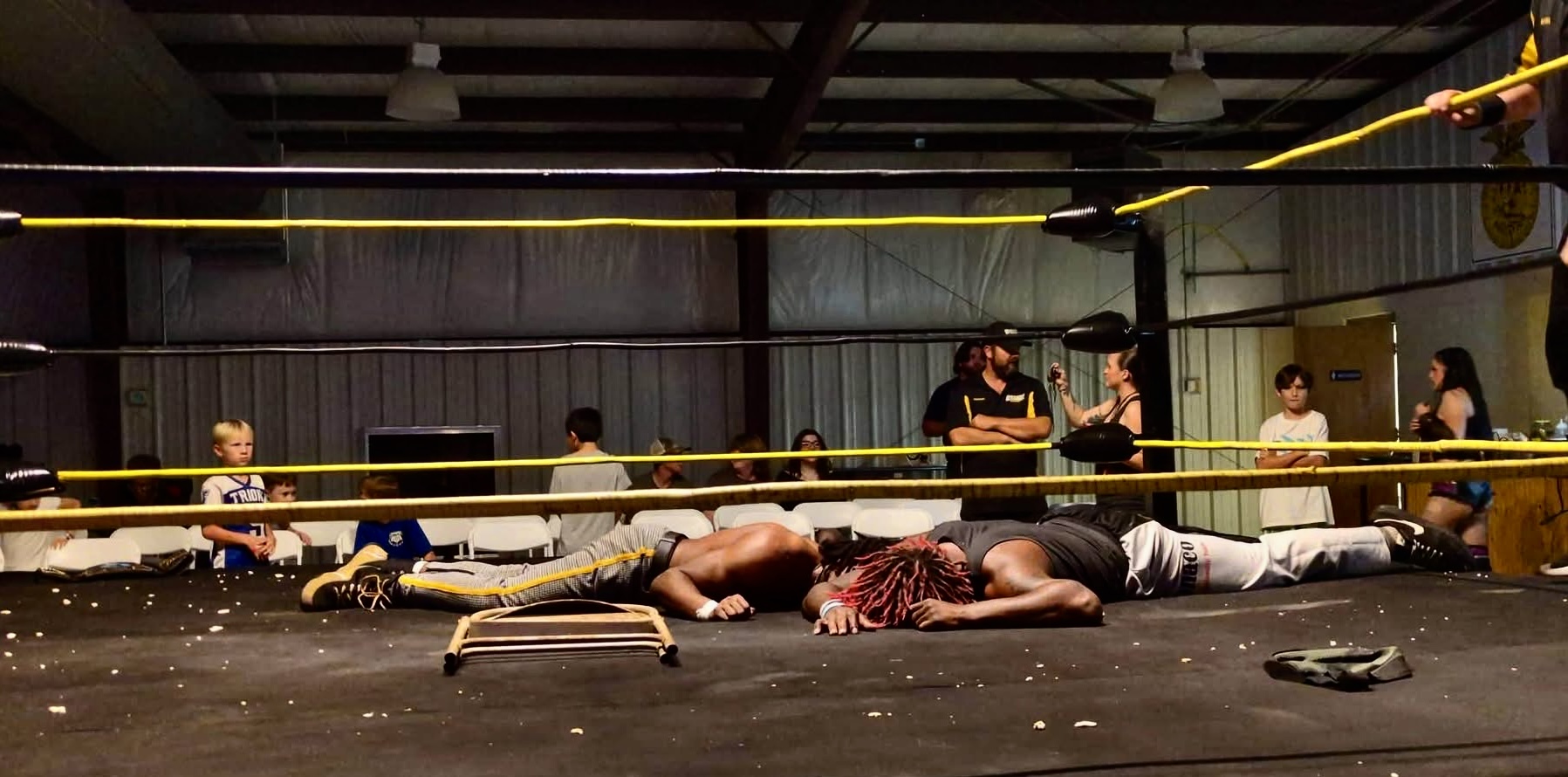 Rico Bravo and BK Bennett lie on the mat after the attack
