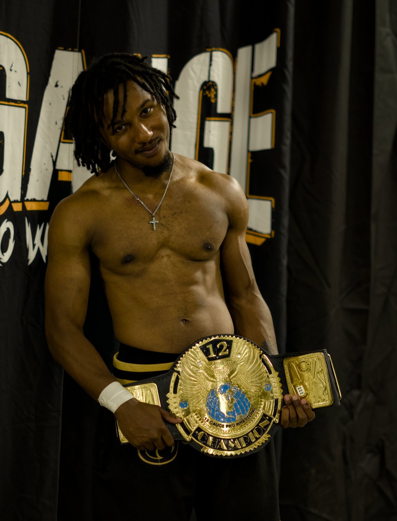 Rico Bravo holding the 12 Gauge Undisputed Championship
